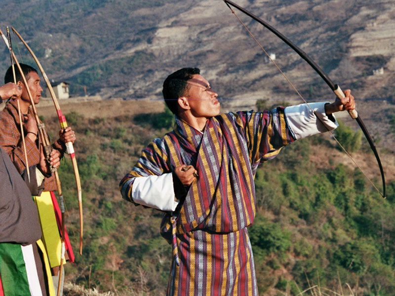 Bhutanese men in gho during a traditional archery match